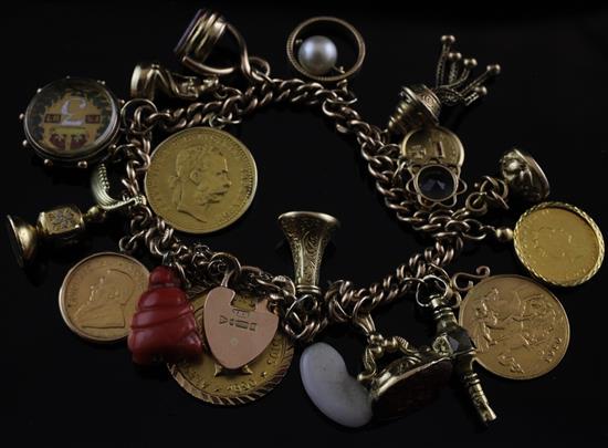 An Edwardian 9ct gold curb link charm bracelet with heart-shaped clasp, gross weight 66.8 grams.